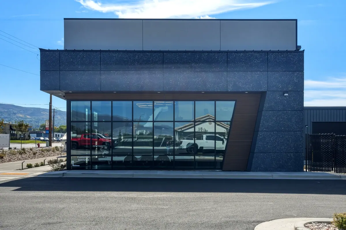 Glass storefront and dark architectural facade at the DC Customs building in Woods Cross, Utah