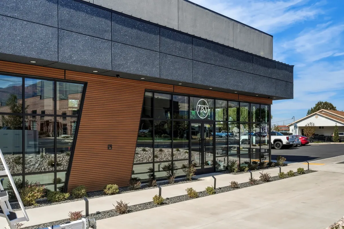 Angled storefront and landscaped pedestrian frontage at the DC Customs building