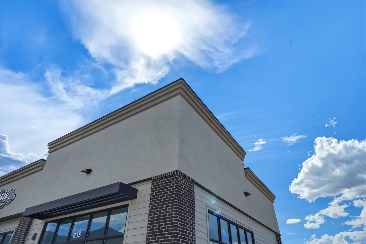 Low-angle detail of the Salem retail building corner, brickwork and roofline