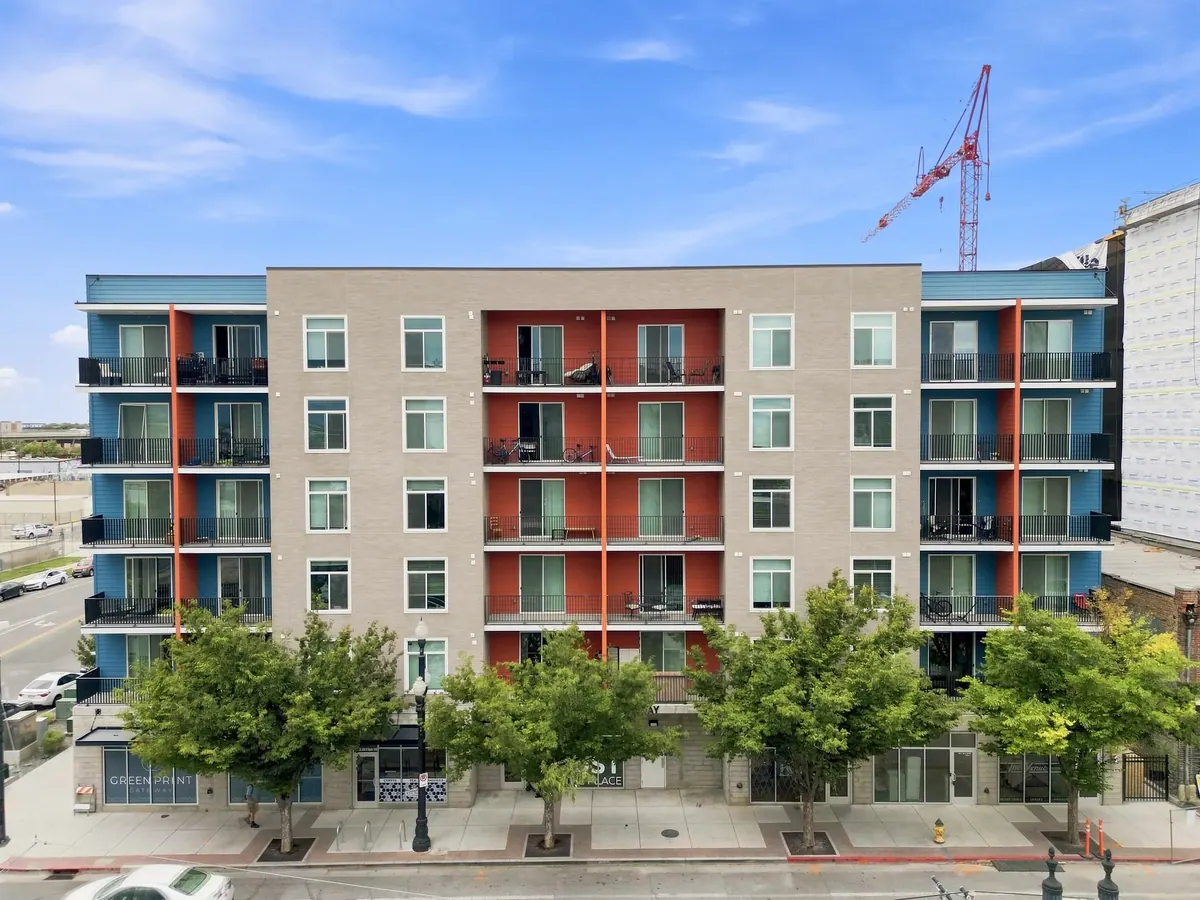 Gateway Apartments multifamily building front elevation with balconies and trees
