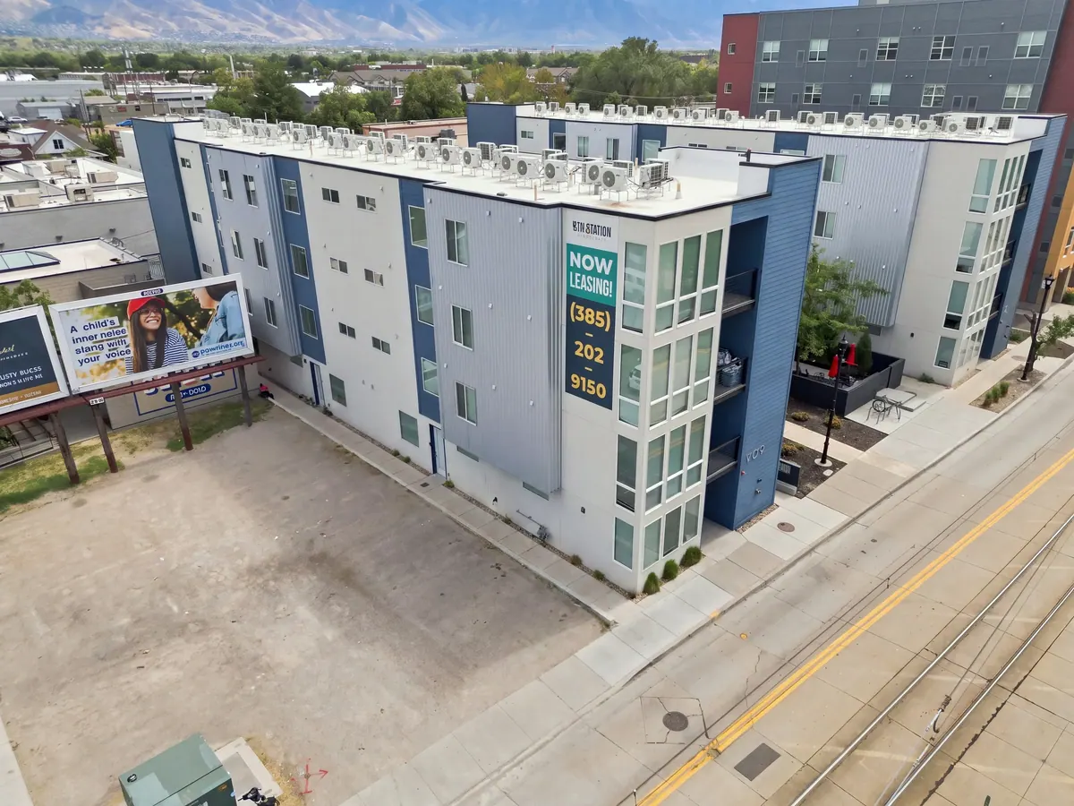 Drone view of 9th Station apartment rooftops and corner facade