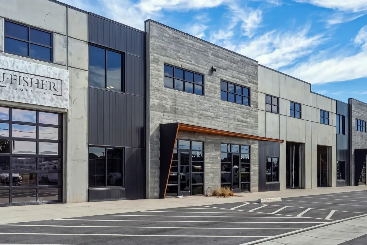 Street-level view of multiple Sky Landing tenant bays with overhead doors and glazed entrances