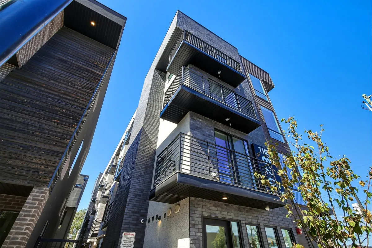 Low-angle view of 820 Lofts corner balconies and modern facade
