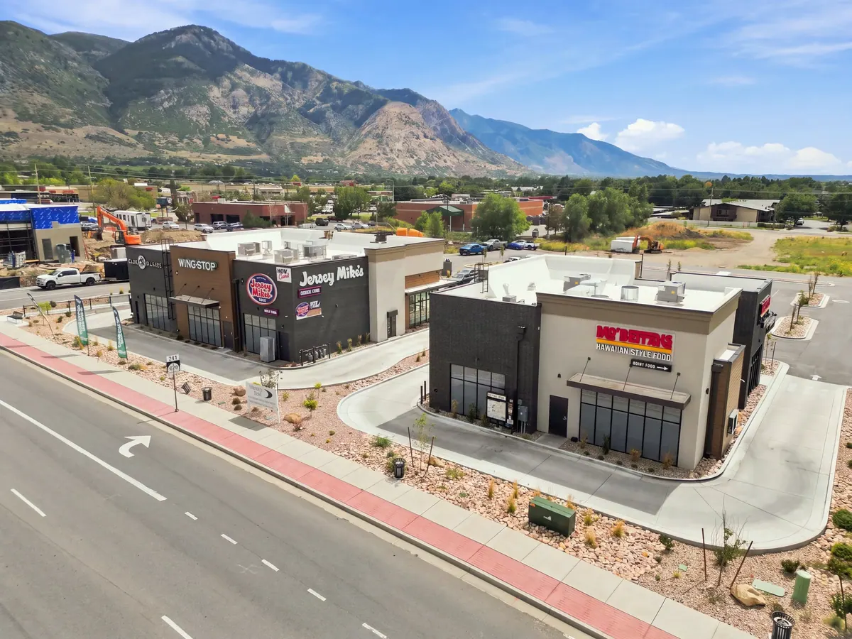 Elevated view showing two North Ogden retail buildings along the street
