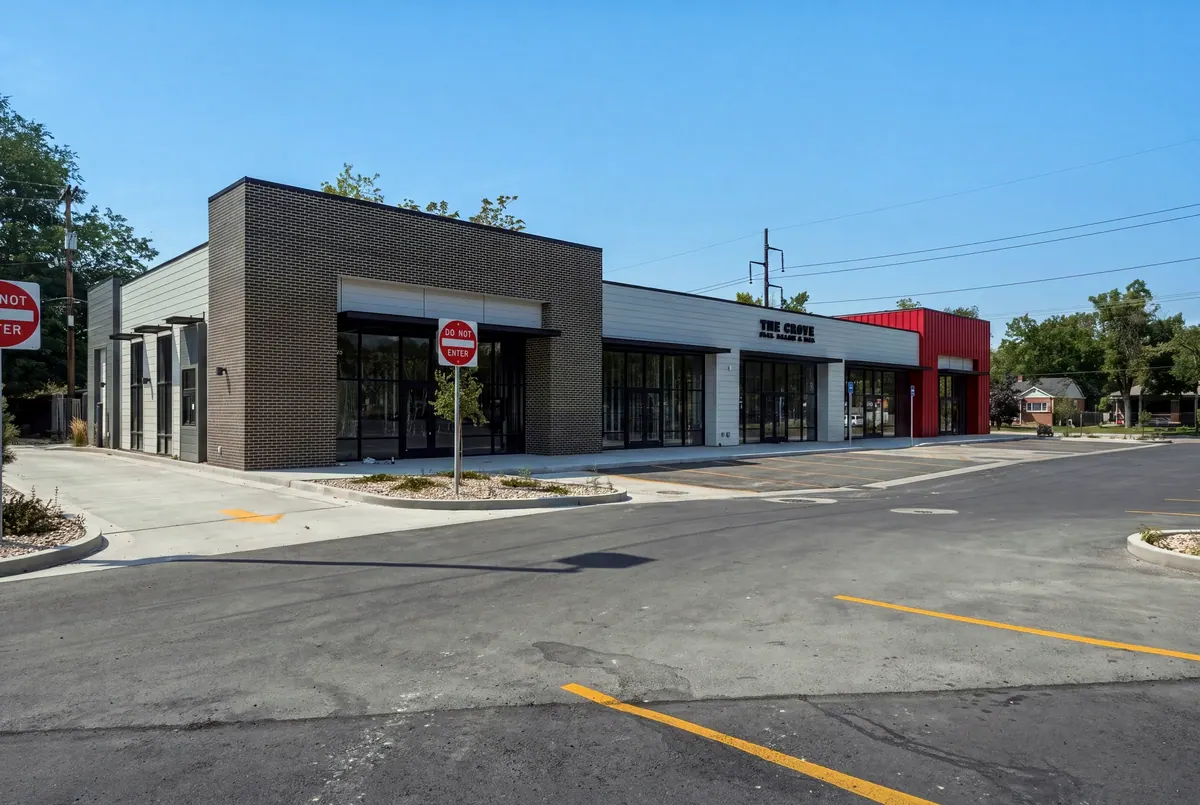 Street-corner view of the 8th and 9th retail building with continuous storefront glazing