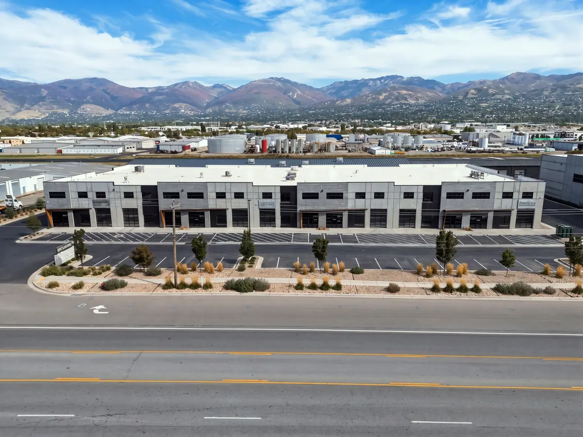 Elevated view of the full Sky Landing flex warehouse frontage, roadway and mountains beyond