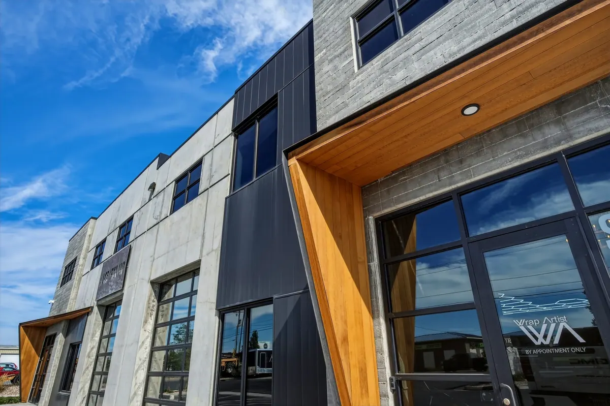 Close-up of Sky Landing storefront glazing, wood-toned entry canopy and contrasting exterior cladding
