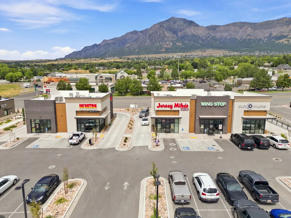Aerial view of North Ogden retail storefronts with mountains in the background